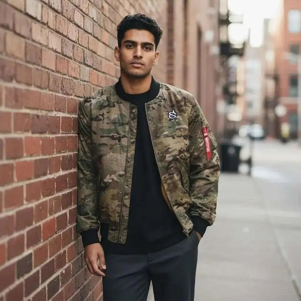 WarriorGear.eu men's multicam camouflage bomber jacket with black collar, cuffs, and hem. Features a red tag on the sleeve.